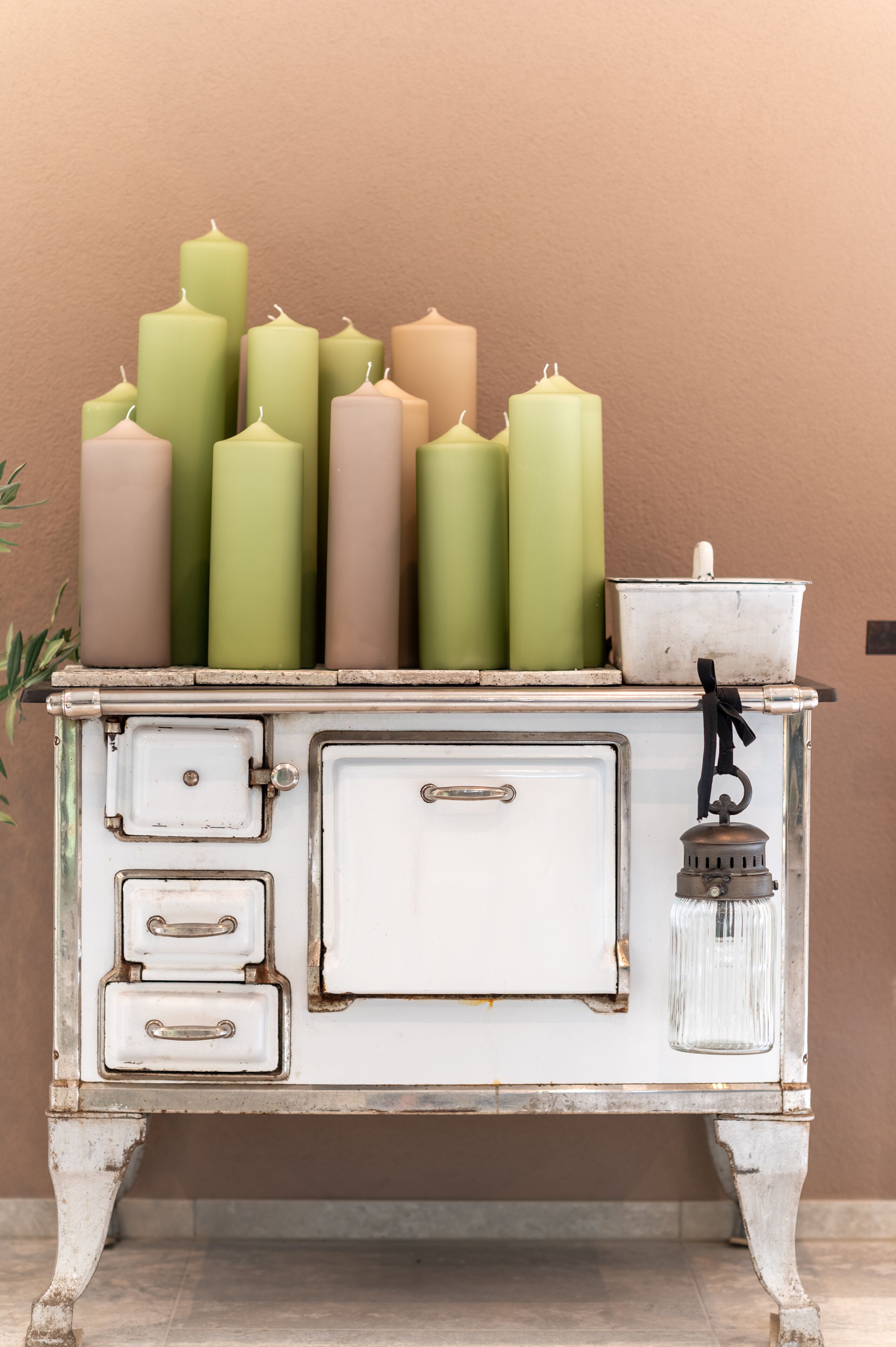 A white vintage-style cabinet with multiple drawers and a small metal container on top.