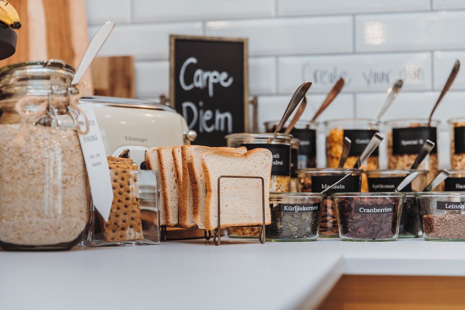 A display of bread and spreads in a bakery setting.
