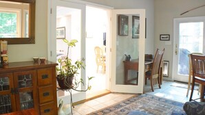 A dining area with a table, chairs, and a potted plant. - Home Away From Home,  pet friendly retreat! (Ocean Pines)