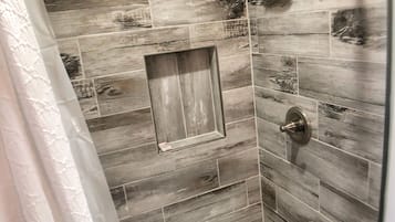 Shower, hair dryer, towels, toilet paper