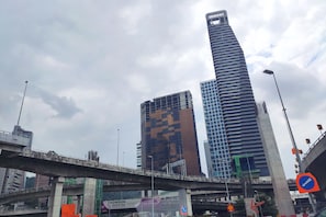 A multi-level urban bridge with modern buildings in the background.