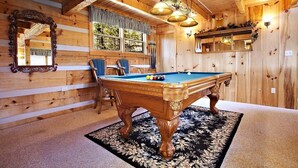 A wooden interior with a pool table, chairs, and a mirror. - AWESOME VIEW! 1 bedroom, sleeps 2! (Sevierville)