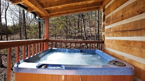 A hot tub in a wooden cabin with a wooden deck and a forest view. - AWESOME VIEW! 1 bedroom, sleeps 2! (Sevierville)