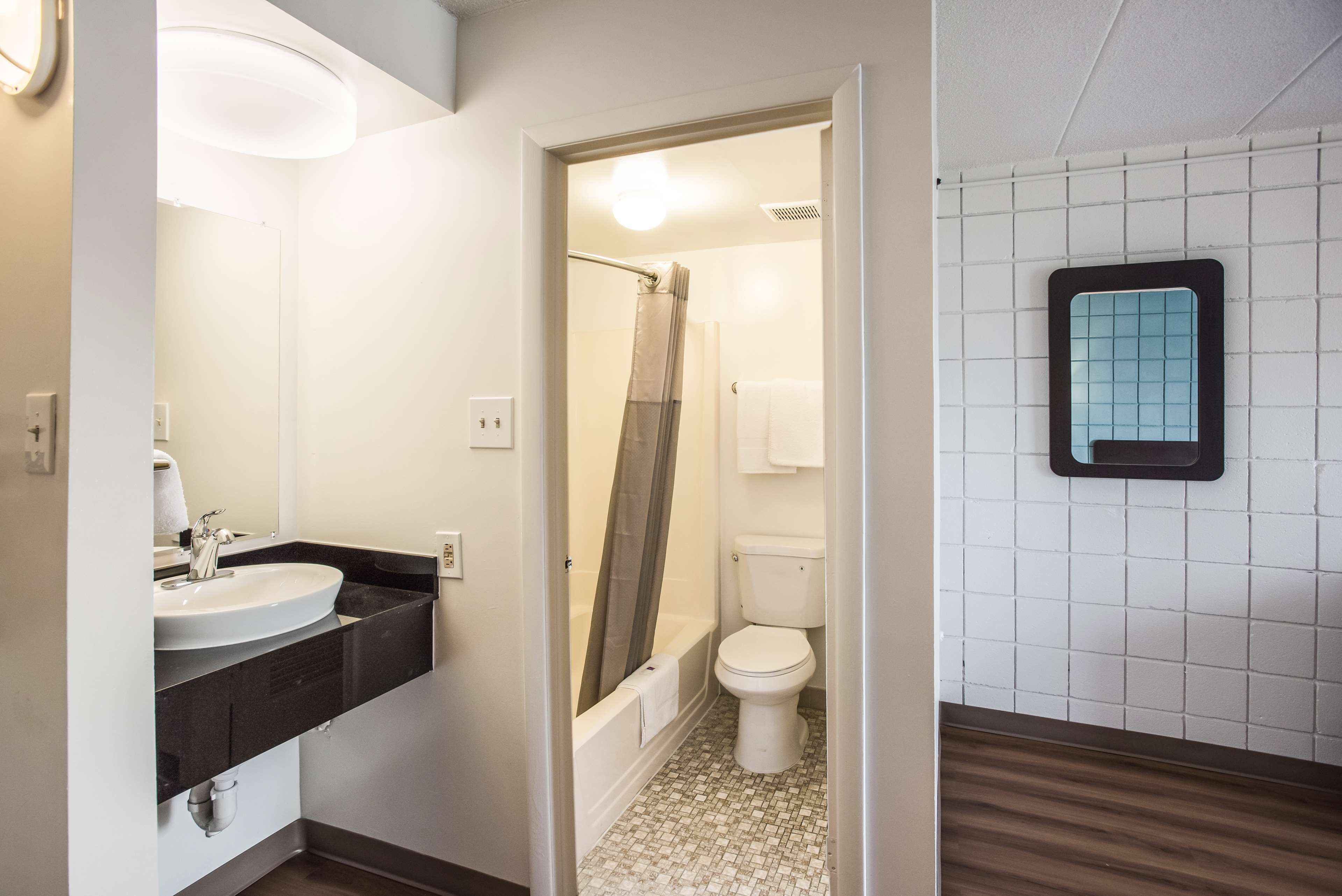 A bathroom with a sink, toilet, and shower.