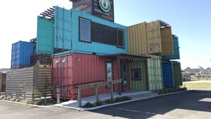 A building constructed from shipping containers with a sign reading "Island Joe's." - Best of Padre Island! Less than 1.5 miles to Luby Beach! (Corpus Christi)