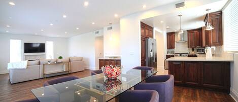 A modern kitchen with wooden cabinets, stainless steel appliances, and a central island.