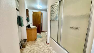 Combined shower/bathtub, hair dryer, towels, soap
