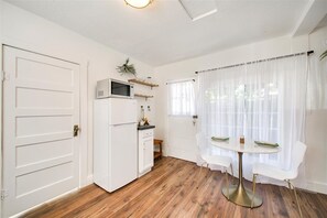 Cozy retreat with a dining area, refrigerator, and microwave.