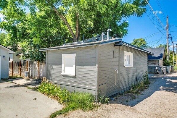 Situated on a quiet property, this single-story home offers a cozy retreat with a front window and a larger side window.