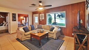 A cozy living room with a sofa set, a coffee table, and a television.