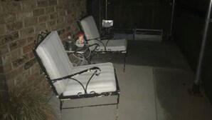 An outdoor patio with two metal-framed chairs and a small table, set against a brick wall. - Best Getaway in East TX! ElKen Retreat:Spa,Pool,Hot tub,Massage,Breakfast,Relax (CANTON)