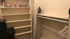A small, empty walk-in closet with shelves and a hanging rod. - Best Getaway in East TX! ElKen Retreat:Spa,Pool,Hot tub,Massage,Breakfast,Relax (CANTON)