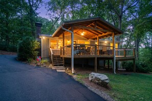 A two-story wooden cabin with a covered deck and a staircase leading to the upper level. - Overlook at Lake Burton - Beautiful views of Lake (Clarkesville)