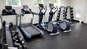 A gym with treadmills, elliptical machines, and a weight rack. - 21-- St George Condo 1king, 1Queen, fold down chair -pool, hot tub. (St. George)