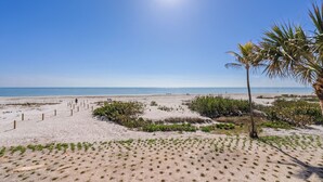 A sandy beach with a clear sky and a palm tree. - OCEAN'S REACH 4C2: 2nd Floor, Beautiful Gulf Views w/Easy Beach Access! (Sanibel Island)