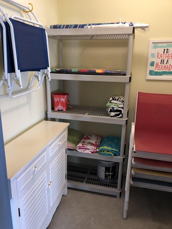 A bunk bed with a desk and storage shelves.