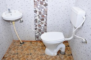 Bathroom features a sink, toilet, and decorative panel with a textured design.