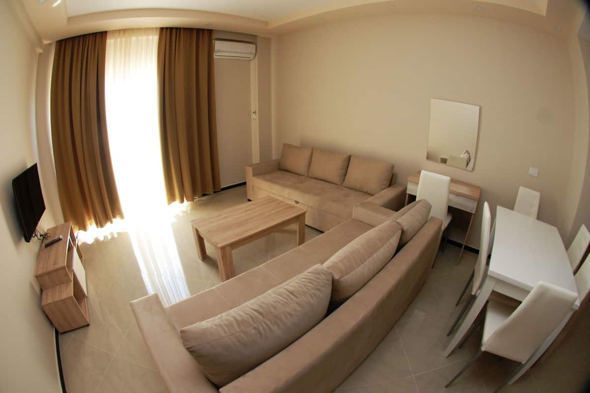 Departamento, 1 habitación | Área de sala de estar | Televisión de pantalla plana 
