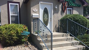 A building with a sign reading "Weight Solutions," a welcome sign, and a mailbox.