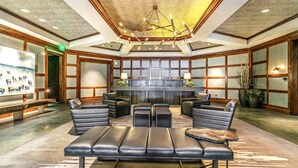 A spacious lobby with leather seating, a large fireplace, and a modern chandelier. - Vail Ritz Carlton Residence with air conditioning! Luxurious Hot Tub/Amenities (Vail)