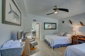 The bedroom has 2 queen beds, TV, wood tile flooring, remote ceiling fan and a leather chair to relax upon. - Lido Key Villa: Walk to Beach, Pool, St. Armands (Sarasota)