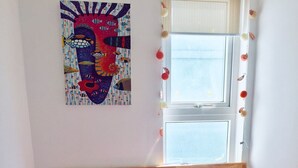 A bed with pink bedding and pillows, a wooden headboard, and a window with curtains. - Friendly host looking for polite guests (Tp. Vũng Tàu)