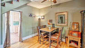 A dining area with a wooden table and chairs, a ceiling fan, and a staircase leading to an upper level. - Home w/ Gas Grill - Walk to Bisbee Brewing Co (Bisbee)
