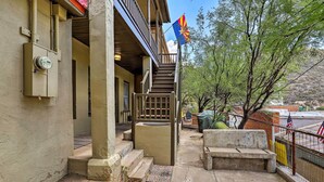 A building with a covered porch, a staircase, and a flag. - Home w/ Gas Grill - Walk to Bisbee Brewing Co (Bisbee)
