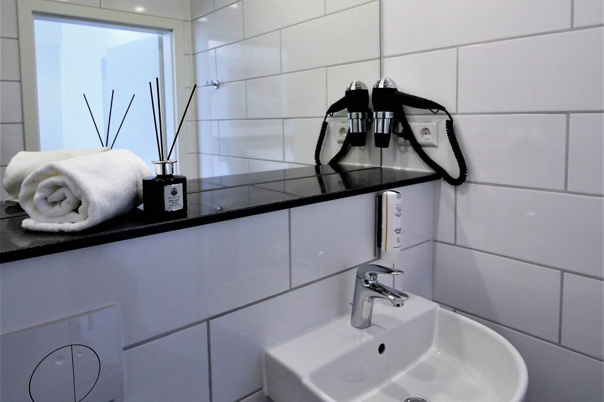 shower, rainfall showerhead, hair dryer, towels