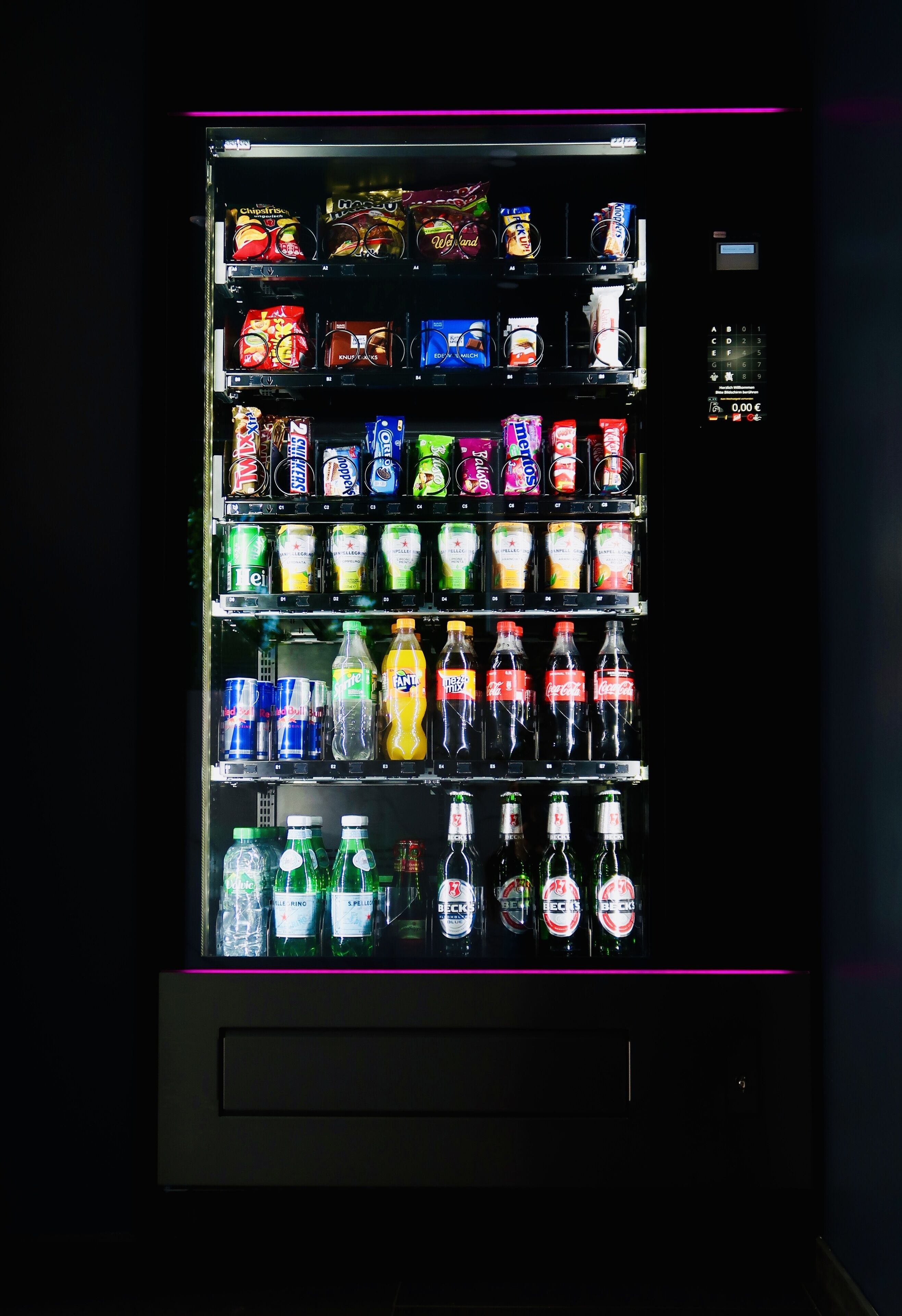 A vending machine with various snacks and beverages.