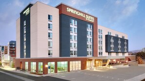 A modern hotel with a prominent sign for Springhill Suites by Marriott, featuring a brick facade, large windows, and a spacious entrance area. - SpringHill Suites by Marriott Salt Lake City Sugar House (Salt Lake City)