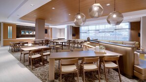 A spacious dining area with multiple tables and chairs, a wooden ceiling, and pendant lighting. - SpringHill Suites by Marriott Salt Lake City Sugar House (Salt Lake City)