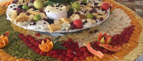 A large fruit and cheese platter with a decorative centerpiece.