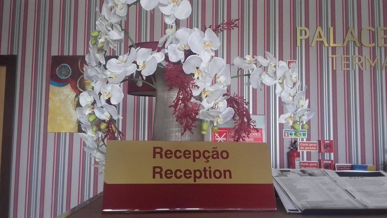 A reception desk with a sign that reads "Reception" in a hotel setting.