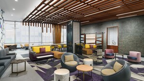 A modern lounge area with seating options including sofas, chairs, and round tables. - Residence Inn by Marriott New York Downtown Manhattan/Financial District (New York)