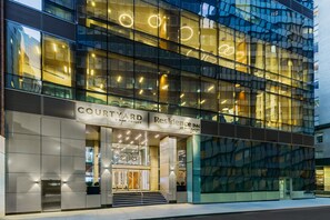 Welcome to Courtyard by Marriott Residence Inn, featuring a sleek glass facade and contemporary architecture.