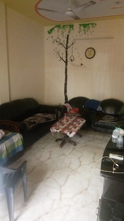 Living area. semi furnished Flat For Rent with one queen size bed and 4 chairs dining table