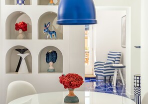 Enjoy a stylish space with a dining table, pendant light, and comfortable chair.