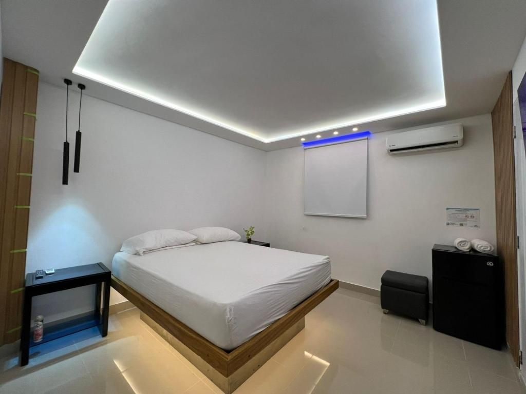 Un dormitorio moderno con una cama, una mesita de noche y aire acondicionado instalado en la pared.