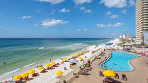 A beach resort with a swimming pool, sun loungers, and beach umbrellas. - Treasure Island 0305 (Panama City Beach)