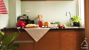 A kitchen with a coffee maker, toaster, and a bowl of fruit on the counter. - quiet, spacious and comfortable studio close to Hanoi Old Quarter (Dong Da)