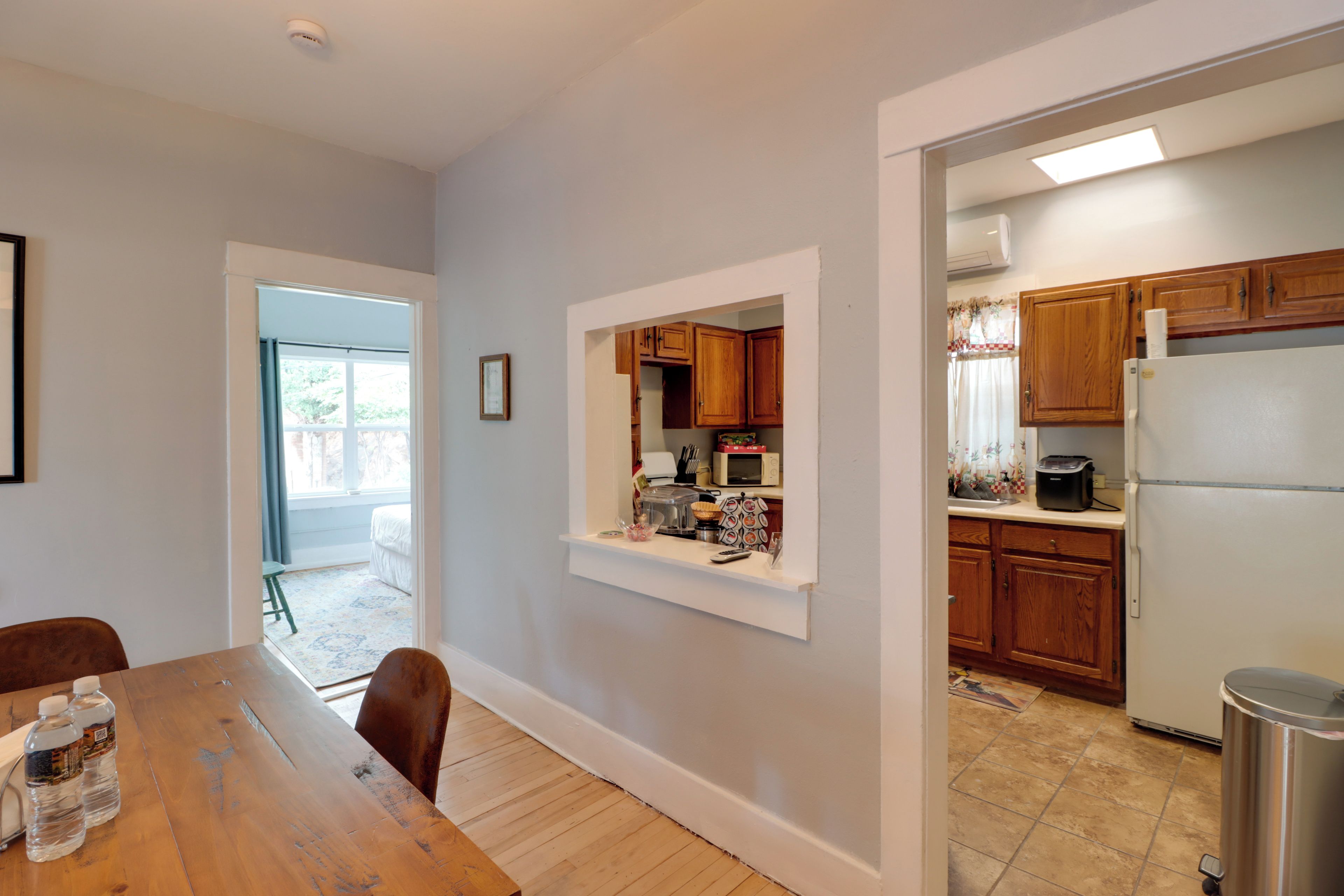 A modern kitchen with wooden cabinets, a refrigerator, and a microwave.