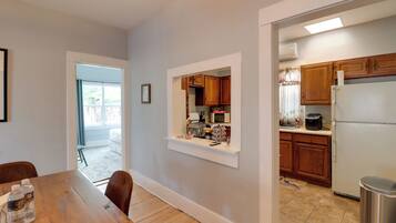 A modern kitchen with wooden cabinets, a refrigerator, and a microwave.
