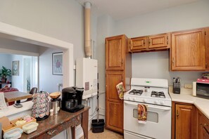 A kitchen with wooden cabinets, a stove, a coffee maker, and a kettle. - 'St Valentine' Apartment w/ Balcony in Bisbee (Bisbee)