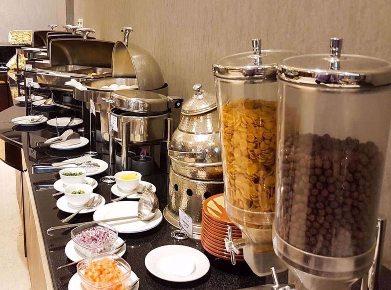 A buffet setup with various food items and containers.