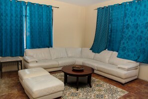 Deluxe Room | Living area | Flat-screen TV