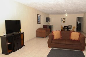 Habitación Deluxe | Área de sala de estar | Televisión de pantalla plana 