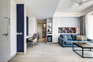A modern living room with a blue sofa, a coffee table, and a TV.