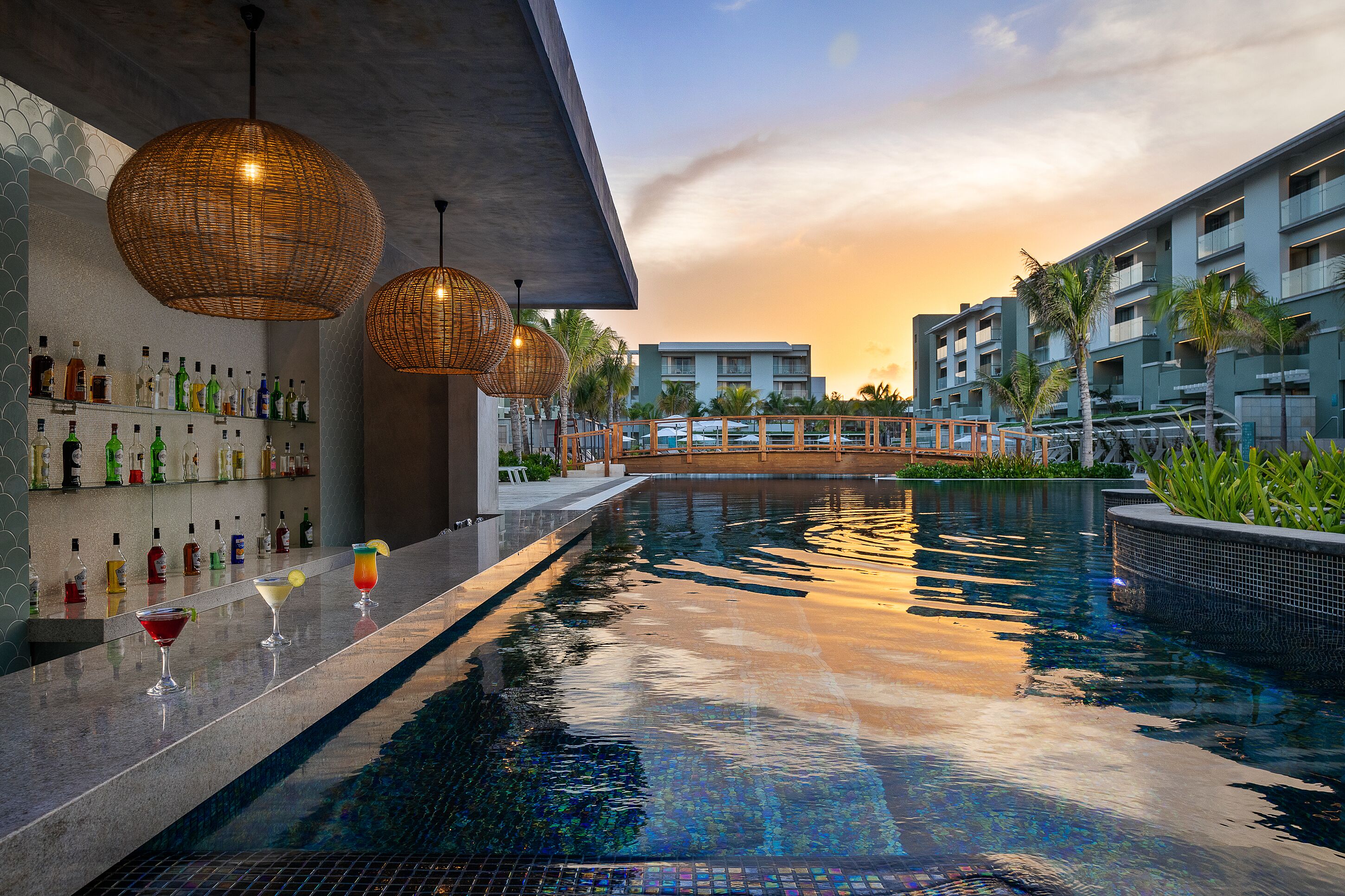 A poolside bar with a variety of liquor bottles and a bar counter.