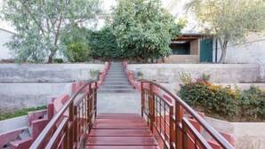 A staircase leading up to a building with a metal railing and steps. - Apartments Cumbaya Quito Ec (Cumbayá)